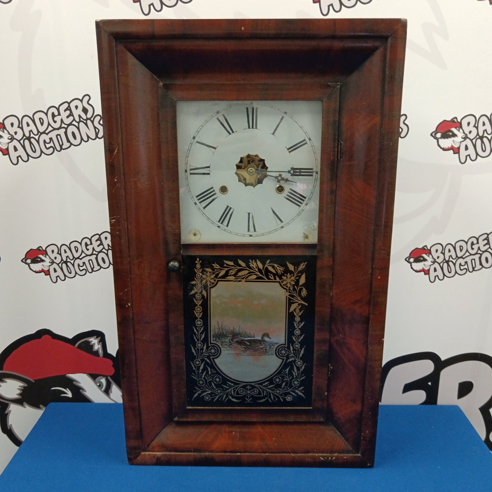 Antique Jerome & Co wall clock with painted scene.