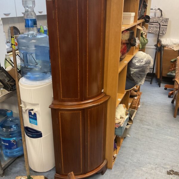 Antique mahogany corner cabinet with satinwood inlay in a room setting.