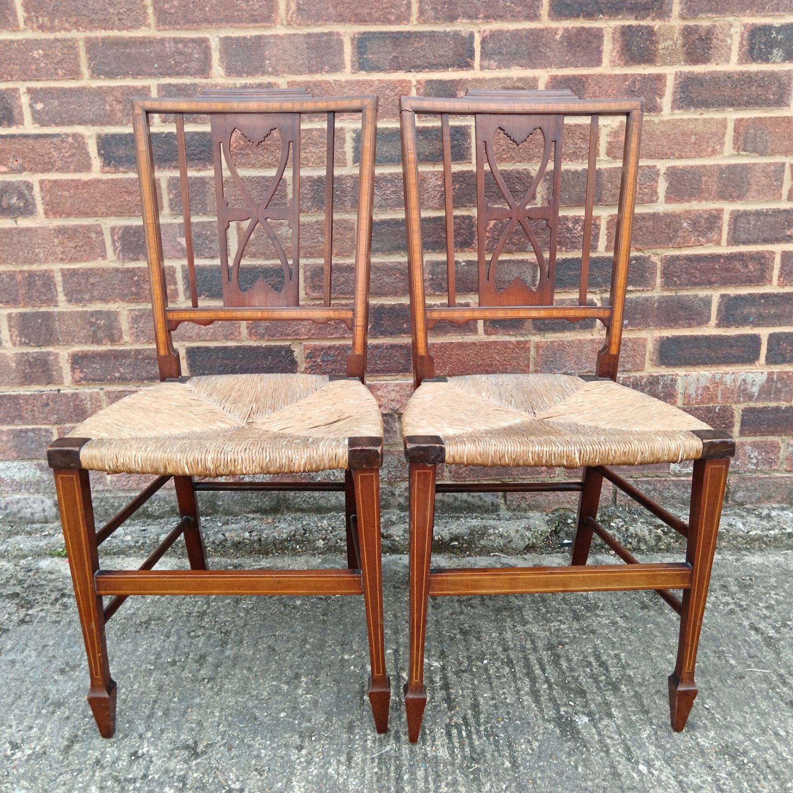 Pair of antique mahogany dining chairs with heart splats.