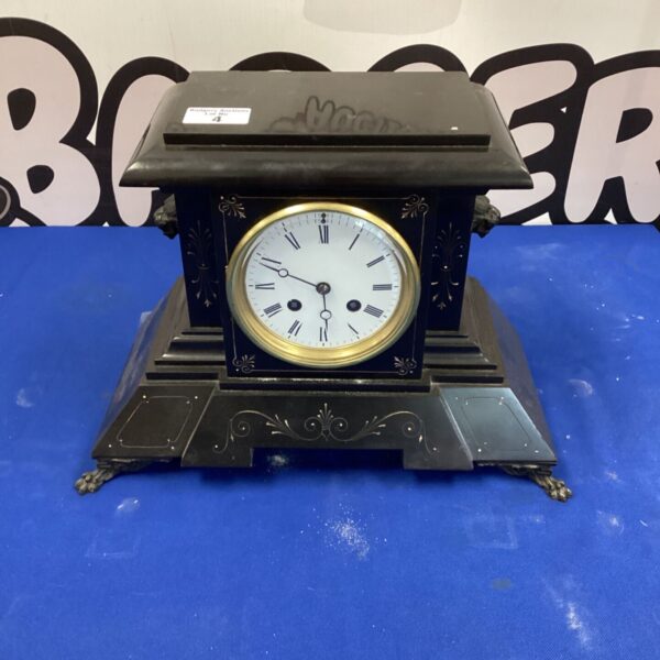 Antique marble mantle clock with bronze feet, a Victorian collectible.
