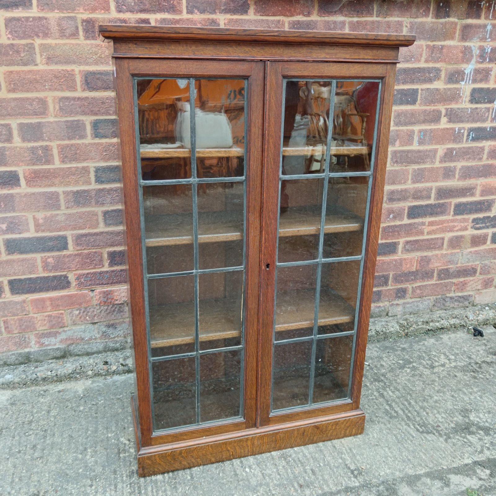 Antique oak display bookcase with glass fronted doors.