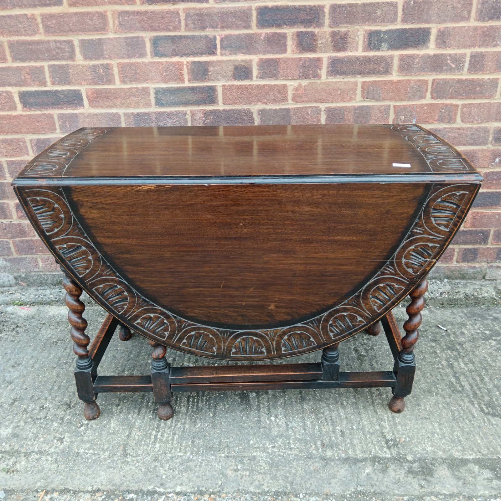 Antique English oak gateleg table with barley twist legs.