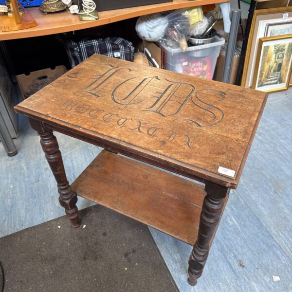 Antique oak hall table with carved top and aged patina.