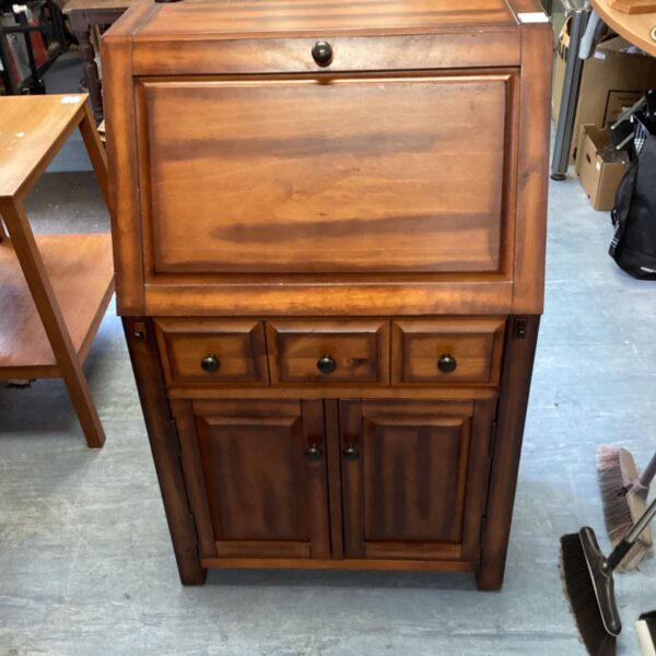 Antique pine bureau with pull-down writing surface and drawers.