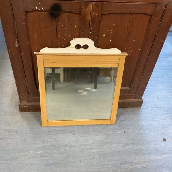 Antique stripped pine farmhouse mirror with a rustic aesthetic.