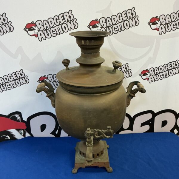 Antique Russian brass samovar with ornate handles and tap.