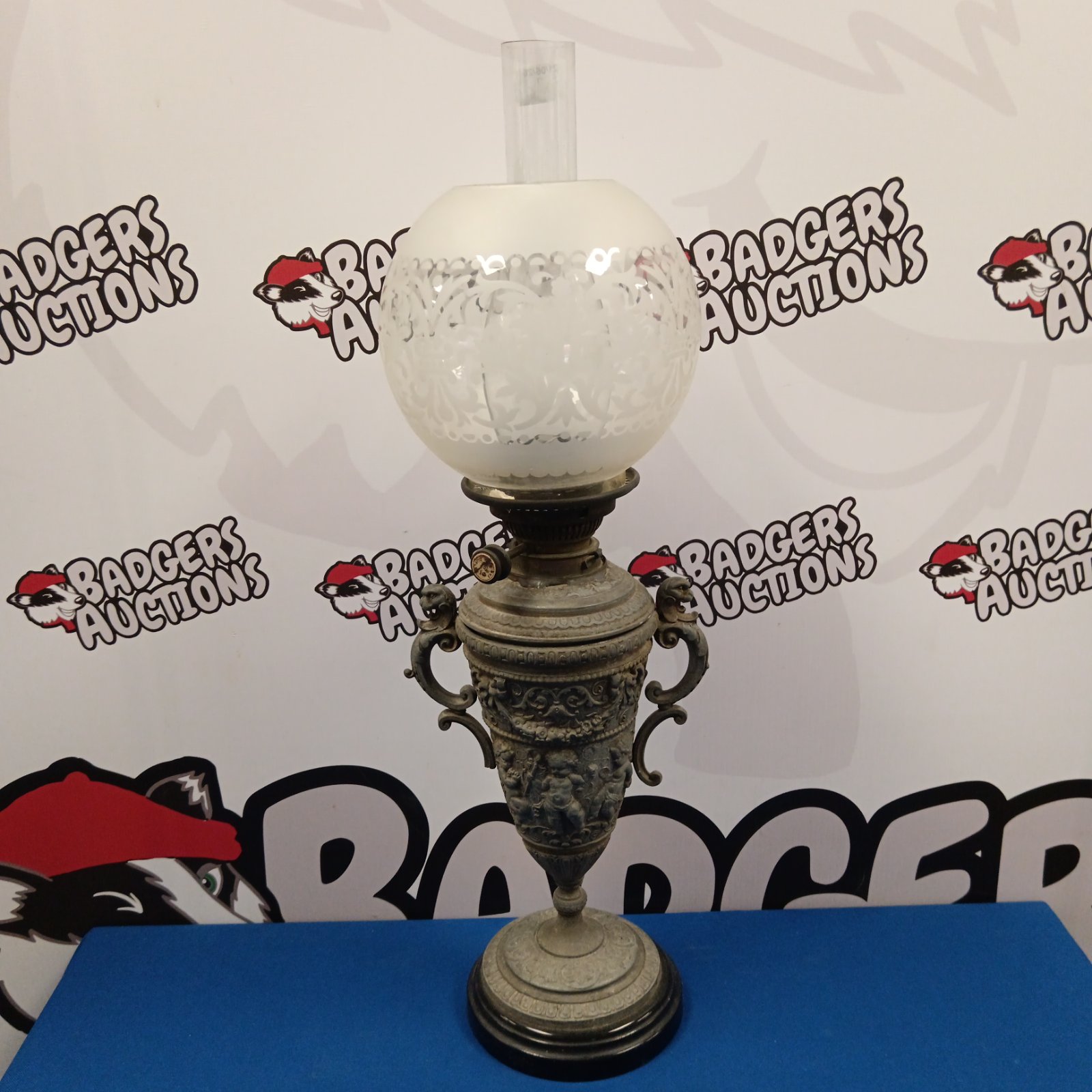 Antique spelter oil lamp with frosted glass shade, Victorian style.