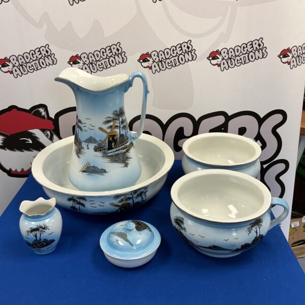 Antique wash bowl and jug set with oriental windmill pattern.