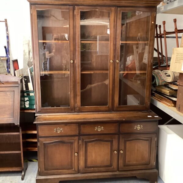 Traditional wooden Welsh dresser with display shelves and cupboards.