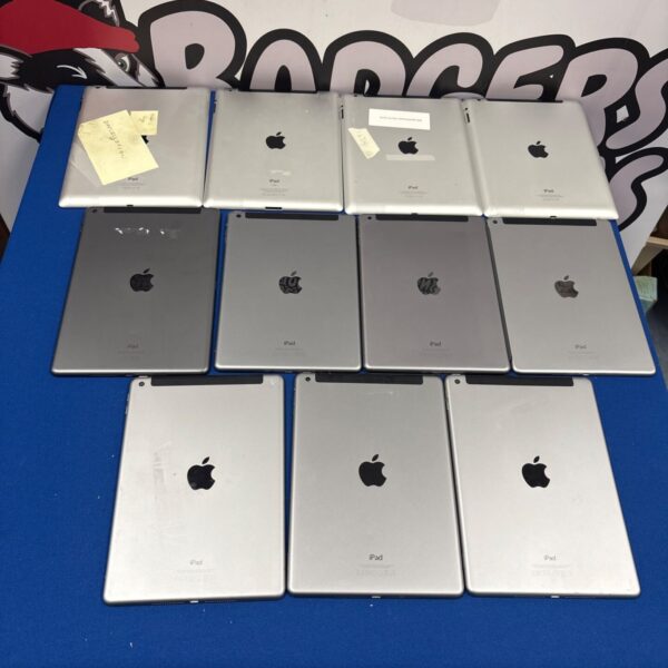 Stack of silver and space grey Apple iPads in a lot.