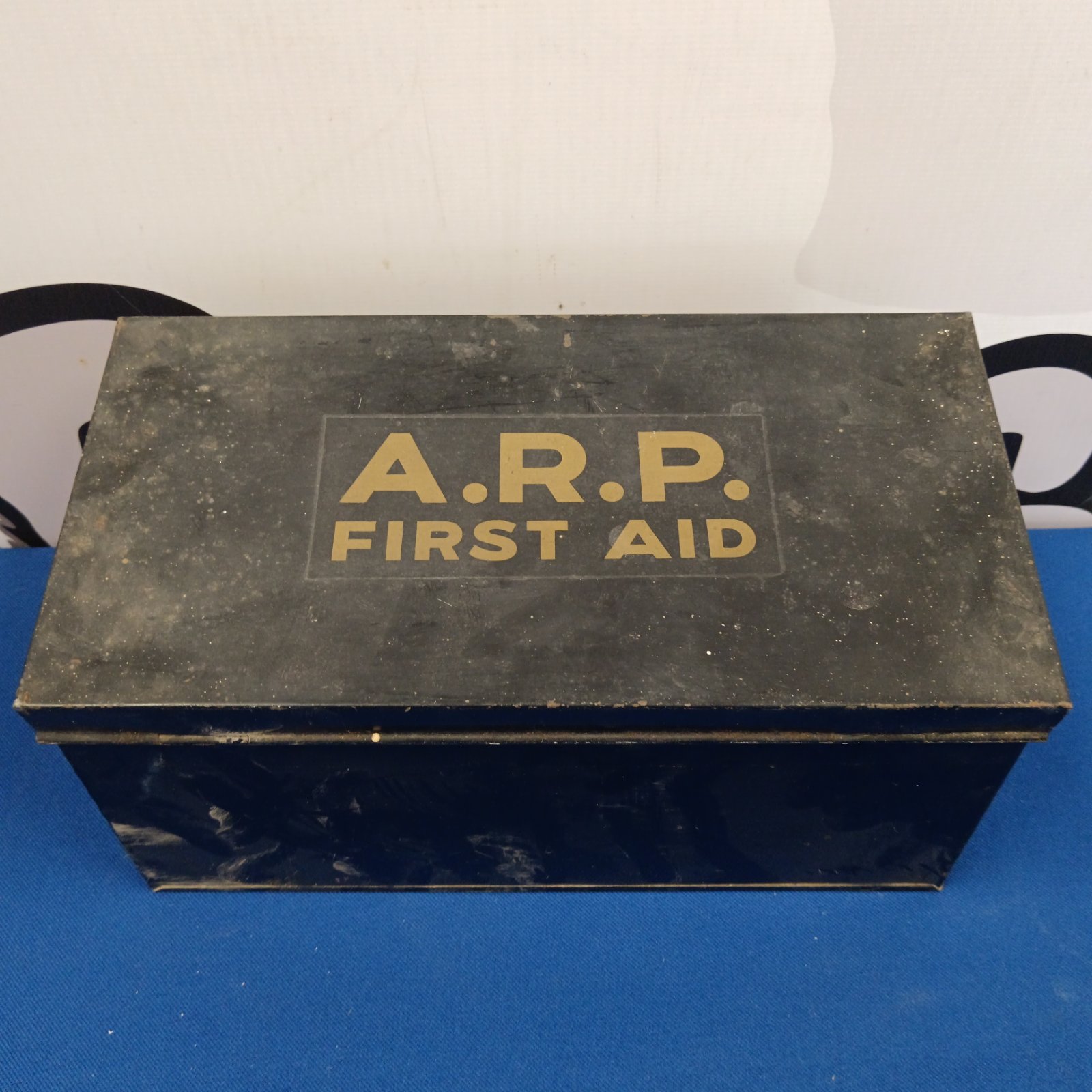 Vintage ARP First Aid tin showing bold lettering.