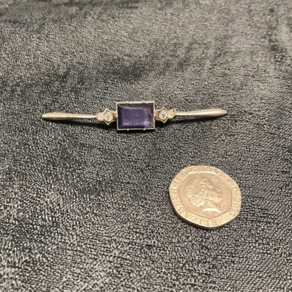 Antique Art Deco brooch with blue and white stones.