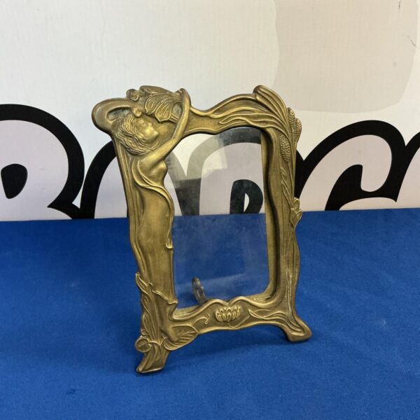 Antique art nouveau brass photo frame with a sculpted lady.