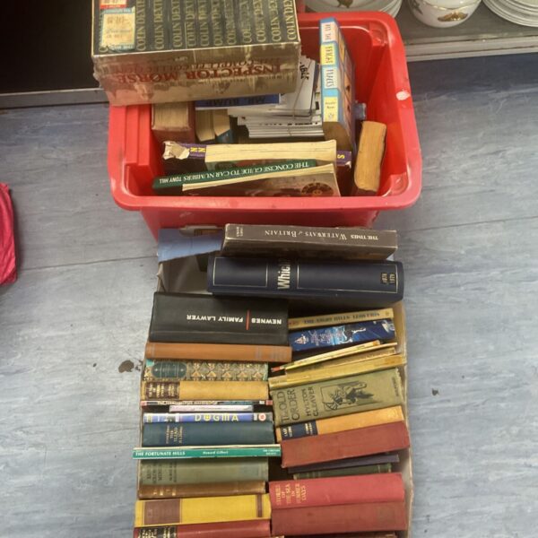Assorted book lot in crates, including sealed Colin Dexter books.