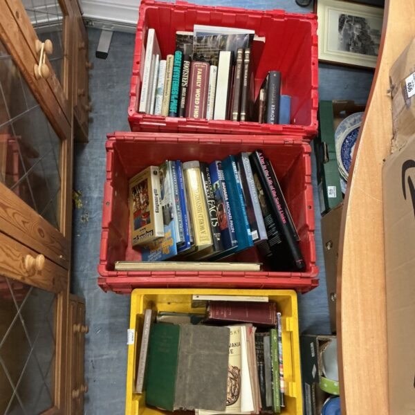 Three boxes filled with assorted books for collectors.