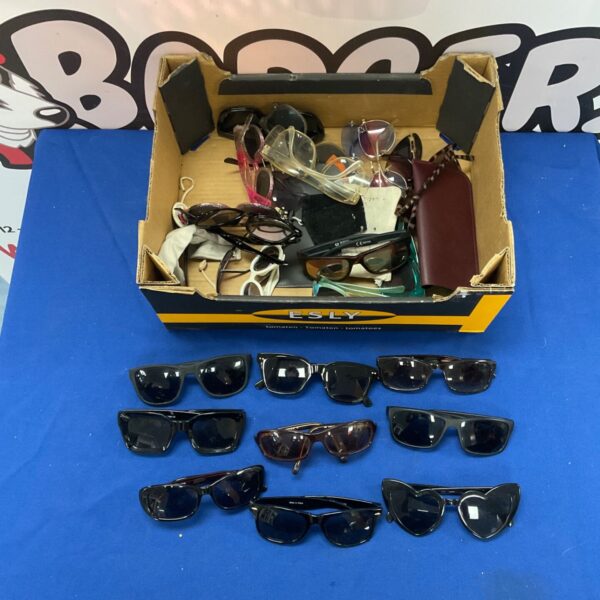 A box filled with assorted vintage and fashion sunglasses.