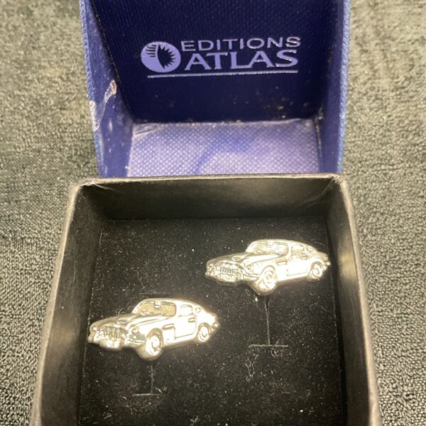 Aston Martin cufflinks in presentation box, luxury car accessory.
