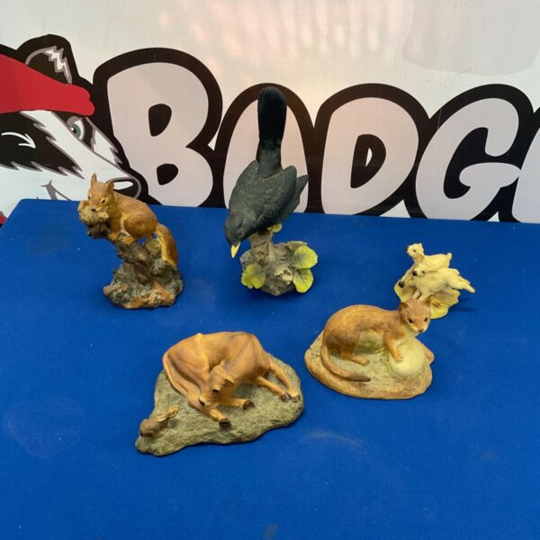 Set of five Aynsley Mastercraft animal figurines on a patterned surface.