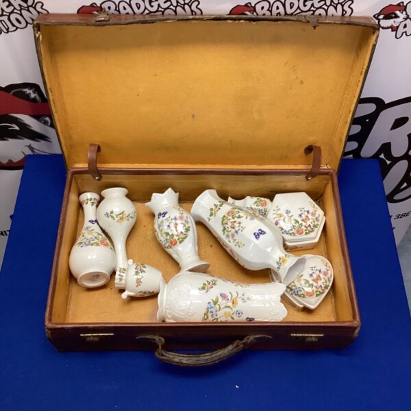 Vintage Aynsley porcelain vases with floral patterns inside a suitcase.