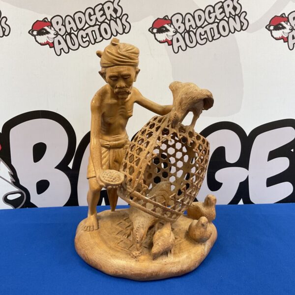 Vintage Balinese wood carving of a farmer with chickens.