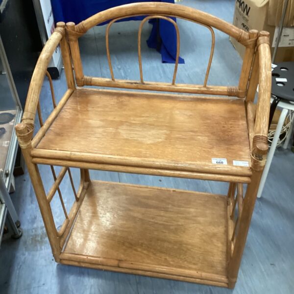 Three-tiered bamboo conservatory table with curved supports.