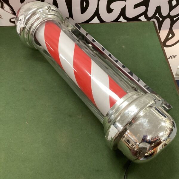 Vintage electric barber pole with red and white stripes.