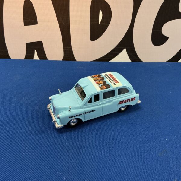 Beatles London taxi diecast model, a collectible piece of memorabilia.