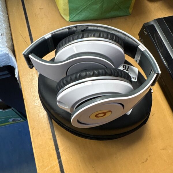 Black Beats Studio headphones with case, vintage audio equipment.