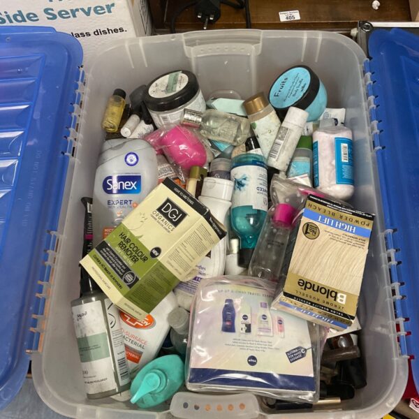 Assorted beauty and hygiene products in a clear storage box.