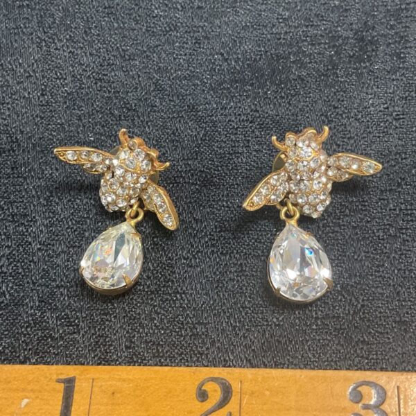 Gold bee drop earrings with sparkling crystal details.