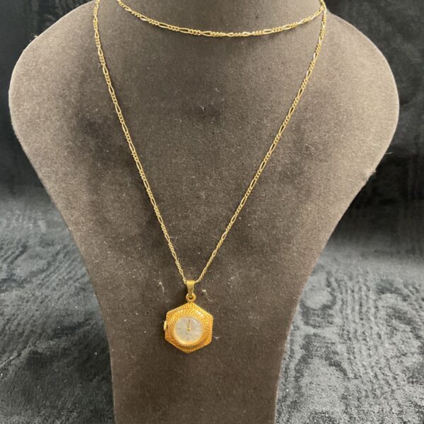 Vintage Belart pendant watch necklace on display.