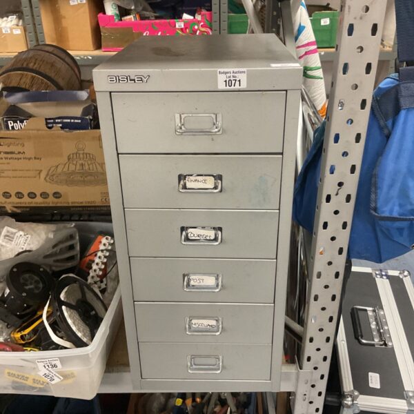 Vintage Bisley metal filing cabinet with four drawers for office storage.