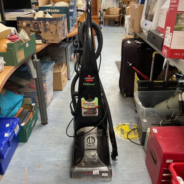 Black Bissell Proheat upright carpet cleaner for home use.