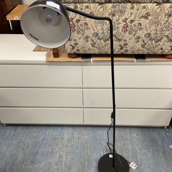 Black floor lamp with flexible head for reading or task lighting.