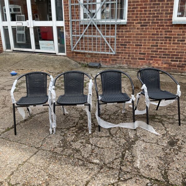 Set of four black garden chairs for outdoor use.