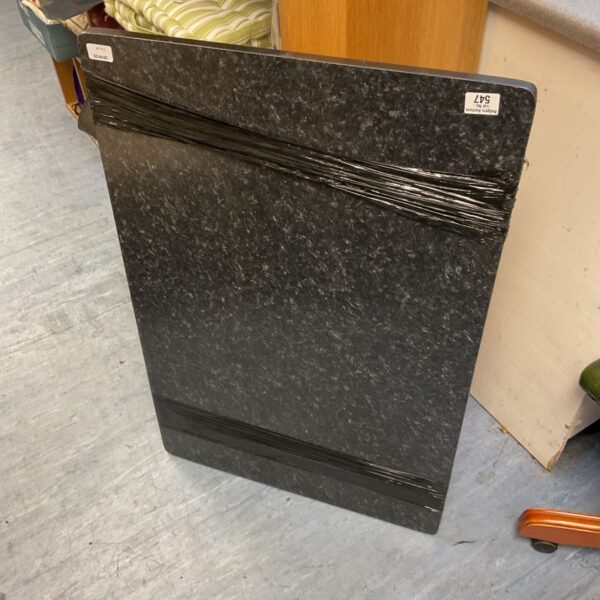 Black lacquer folding dining table in a room setting.