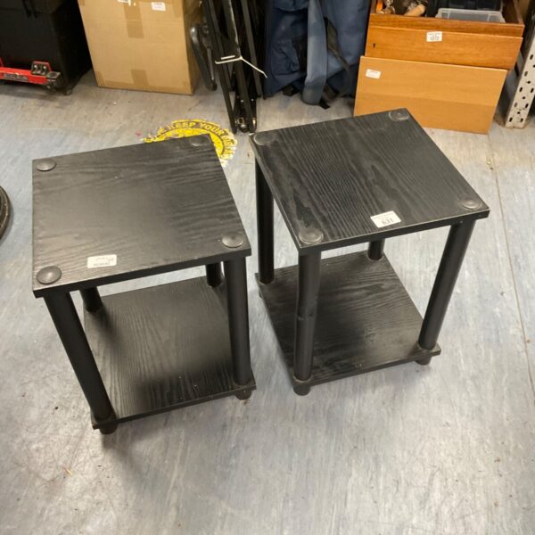 Pair of black wood effect side tables in a room setting.