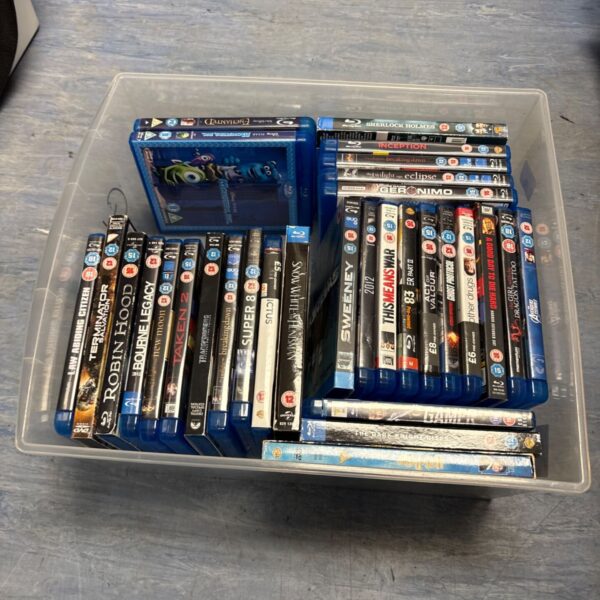 Mixed lot of Blu-Ray movies in a plastic container.