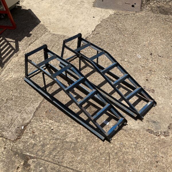 Blue metal car ramps for vehicle maintenance and repair.