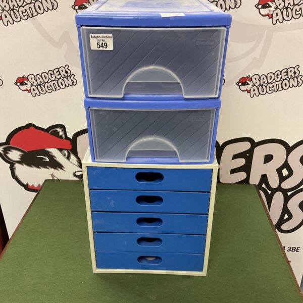 Blue plastic desk organiser boxes for stationery and paperwork.