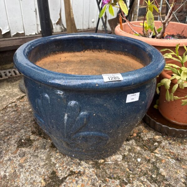 Vibrant blue glazed terracotta planter for garden plants.