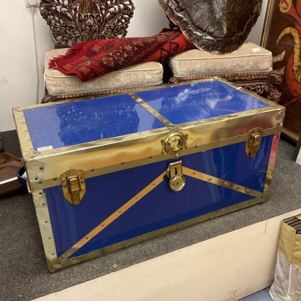 Vintage blue metal trunk with secure lock.
