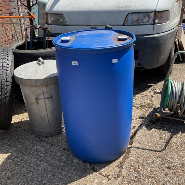 Blue Schutz water barrel in a garden setting.