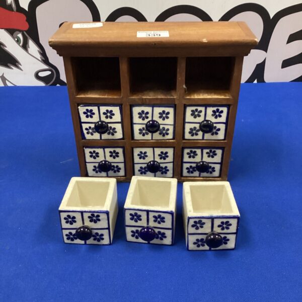 Vintage blue and white ceramic spice drawers in oak case.