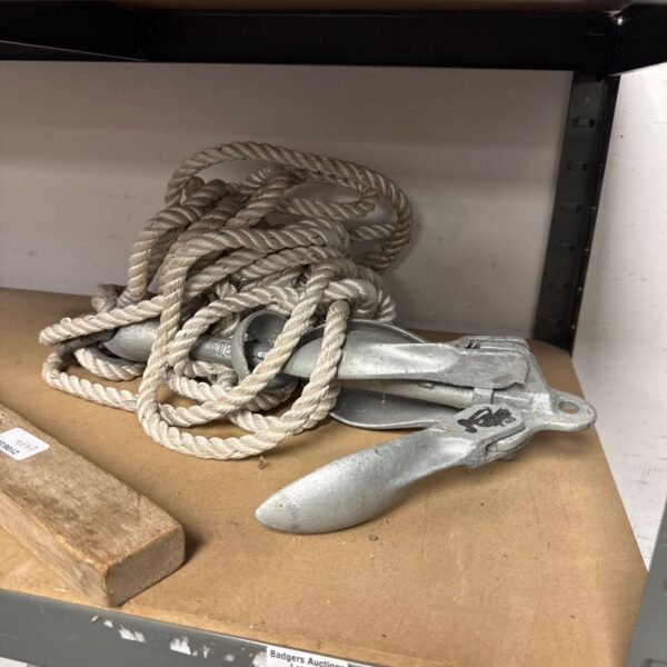 Metal boat drag anchor with attached nylon rope.
