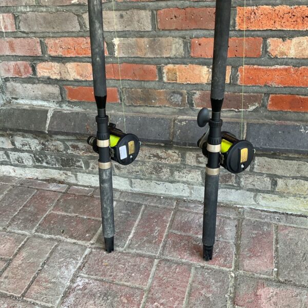 Two boat fishing rods with Shimano TLD 20A reels against a brick wall.