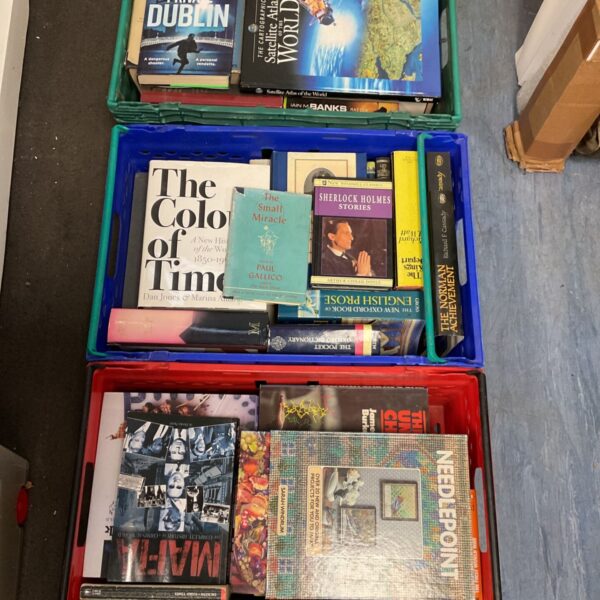Assorted book lot with Sherlock Holmes and atlas visible.