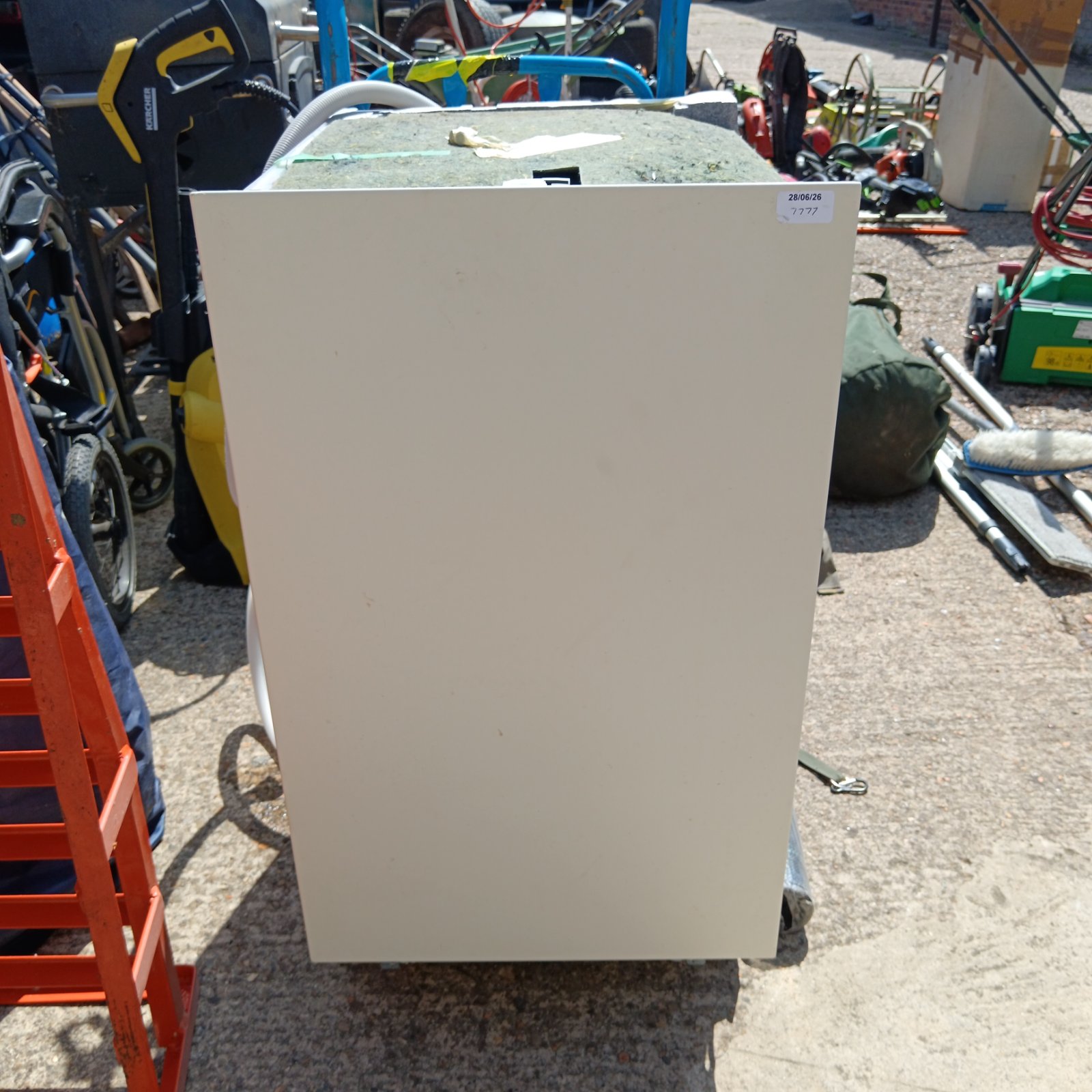 White Bosch slimline dishwasher in an outdoor setting.