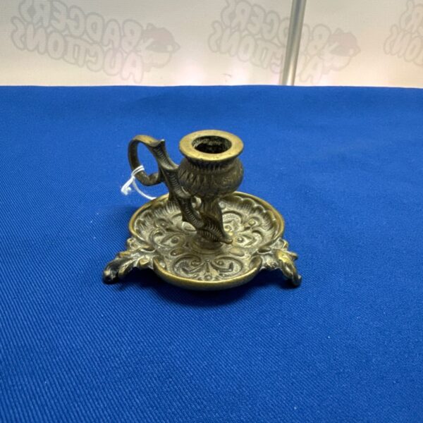 Vintage brass chamber stick with thistle pattern for antique collectors.