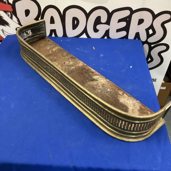 Antique brass fire surround, a vintage fireplace hearth accessory.